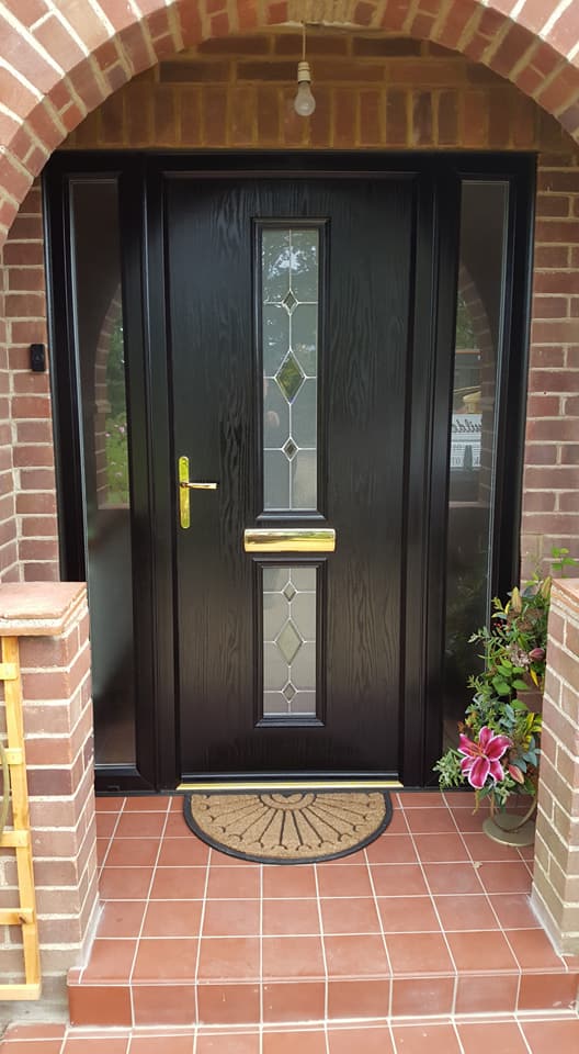 Remove old front door, enlarge opening, lay soldier course of bricks across the top and new door with sidelights fitted.