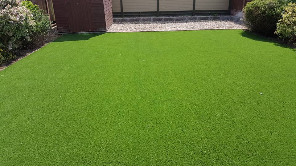 Existing lawn dug up, all necessary preparation work carried out and artificial grass laid.