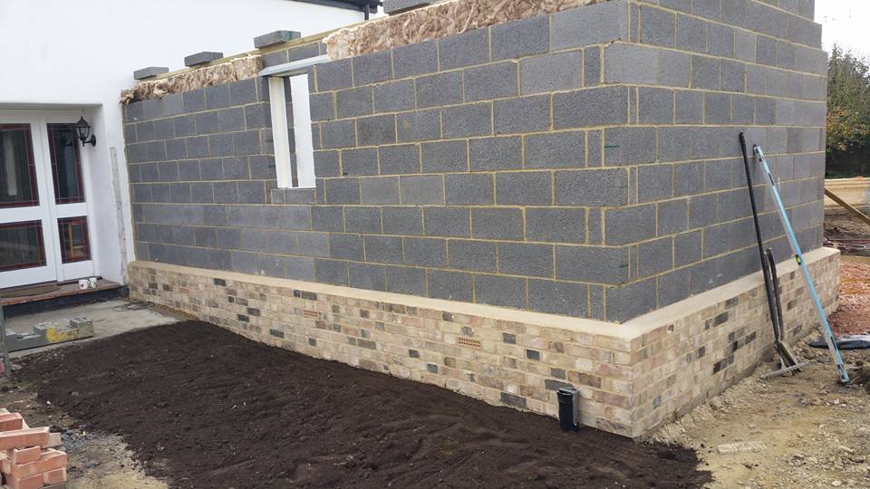 1 of 2: Extension being built, brick plinth, walls finished off with timber cladding and a pan tile roof, all done so as to keep in character with local area.
